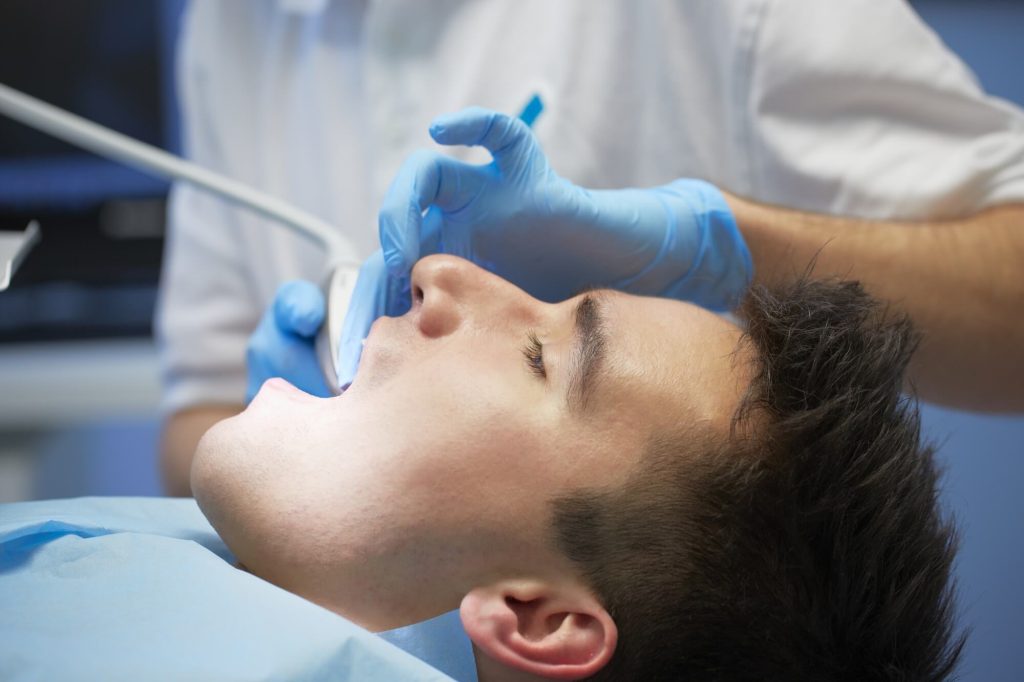Male patient getting dental treatment